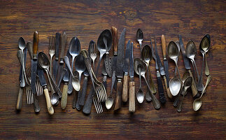 Old cutlery on a wooden background