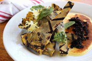 Grilled baby artichokes with black olive crumbs and zabaglione sauce