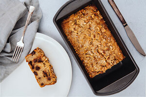 Freshly baked chocolate chip banana bread loaf topped with walnuts