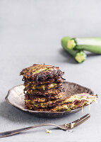 Stacked zucchini pancakes on a metal plate