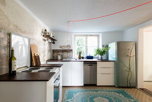 Various modules and painted fridge in kitchen of period building