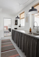 Black-and-white striped curtains below kitchen counter
