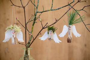 Angels made from wood, paper wings and pine-needle and moss hair