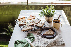 Rosmarinkuchen und ein Becher Tee auf Tisch