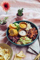 Vegan Mexican Bowl with oven-roasted corn and walnut and carrot chilli
