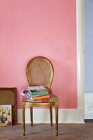 Gilded medallion chair against pink wall
