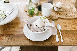 A white Easter place setting with a cloth napkin