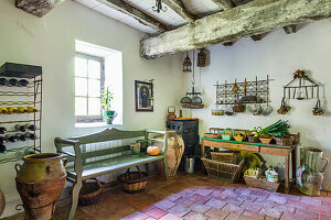 Shelves, amphorae, wooden bench and table in pantry