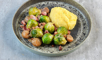 Fried Brussels sprouts and bacon with chestnuts and polenta