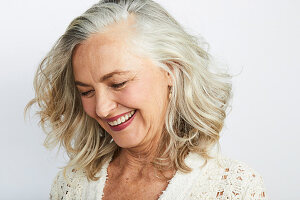 A smiling, grey-haired woman