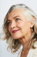 A grey-haired woman wearing subtle make-up