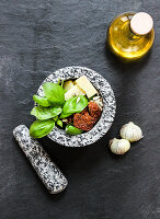 Ingredients for tomato pesto in a mortar