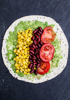 Wraps with avocado, sweetcorn, kidney beans and tomatoes