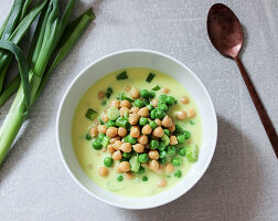 Vegan chickpea soup with green peas and coconut milk