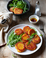 Fried sweet potato pancakes with rucola salad