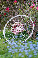 Kranz aus Apfelblüten-Zweigen auf alter Fahrradfelge