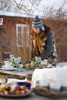 A woman decorating a table in the garden