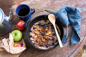 Warm apple and cinnamon porridge in a Dutch oven