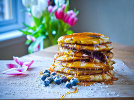 Pancakes with blueberry jam and maple syrup