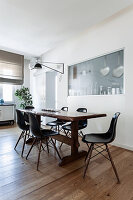 Wooden table with black classic chairs in dining area