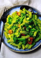 Rotini pasta with basil pesto, broccoli and tomatoes
