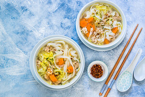 Spring vegetable soup with dumplings and rice noodles
