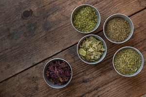 Variety of dried herbs in small bowls
