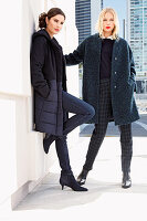 Two young women in winter fashion in shades of blue on the street