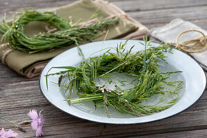 Grass wreath floating in a bowl of water