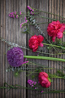 Tableau of ingredients for an early summer bouquet of peonies, alliums, sea lavender, love-in-a-mist and eucalyptus