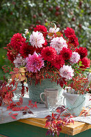 Autumn dahlia bouquet with rose hips and wild vine tendrils