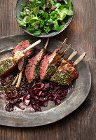Roe deer venison with herb crust on red onions