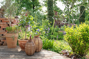 Woven lanterns and plant pots on a wooden terrace