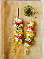 Fish skewers with chimichurri on a baking tray