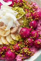 A smoothie bowl with silken tofu, raspberries and dragon fruit (close up)