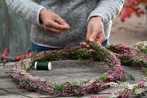 Tying garland from budding heather