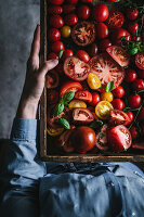 Multicoloured tomatoes in a rustic wooden crate