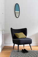 Vintage armchair with a throw pillow resting on it in the corner of the room