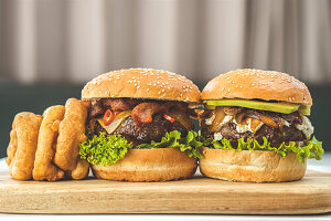 Cheese burger with chilli, bacon, onion rings and burger with avocado, feta, caramalised onions