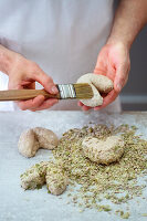 Rye heart rolls being pressed into seeds