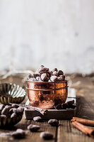 Bowl of homemade roasted almonds with chocolate and gingerbread spice