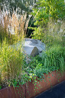 Planted bed with rocks and corten steel edging