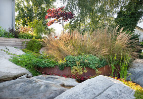 Bed with weathered steel edging between rocks