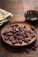 Pecans on a wooden plate