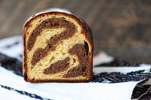 Cozonac - Sweet Easter loaf with walnuts on a traditional towel