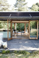 View over the wooden terrace into glass house