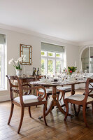Set dining table with chairs and antique console in the dining room