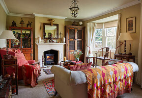 Traditional-style living room with fireplace and patterned throw blanket