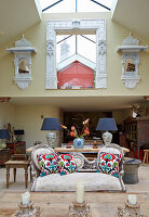 Living room with white vintage sofa and Indian wall shelves