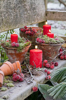 Advent wreath made of clay pots with ornamental apples